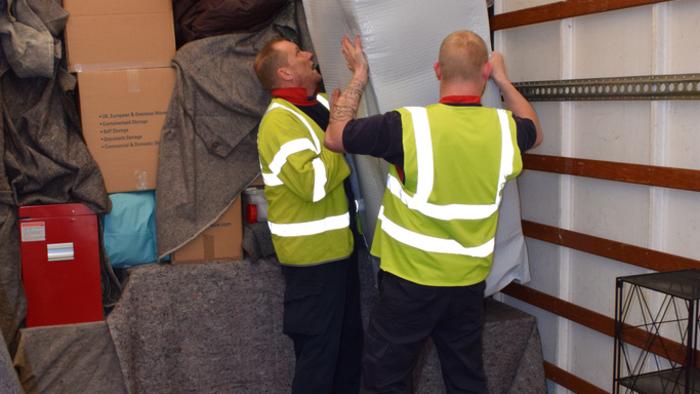 Stacking furniture on a removal van..professionals at work